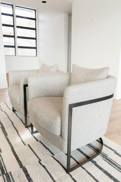 Down to Earth Projects | Salt Lake Residence - two cream chairs on a cream rug 