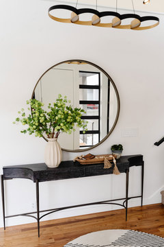 Down to Earth Projects | Salt Lake Residence - entry table with round mirror over it 