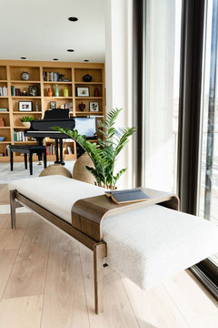 Down to Earth Projects | Salt Lake Residence - cream bench with grand piano and shelves 