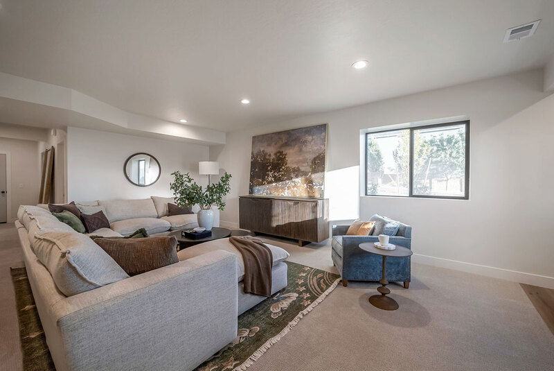 Down to Earth Projects<br>Symphony Homes Parade Ninth + North Design - Down to Earth Projects<br>Symphony Homes Parade Ninth + North Design - basement family room with sectional