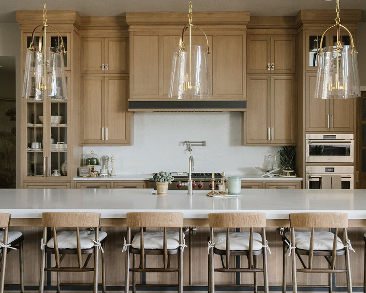 Down to Earth Projects | Utah Valley Parade at The Legacy at Meadow Ridge - Down to Earth Projects | Utah Valley Parade at The Legacy at Meadow Ridge - kitchen with barstools around island and pendant lights