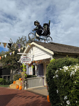 Gardner Village Witch Displays - witch on a bike on a roof 