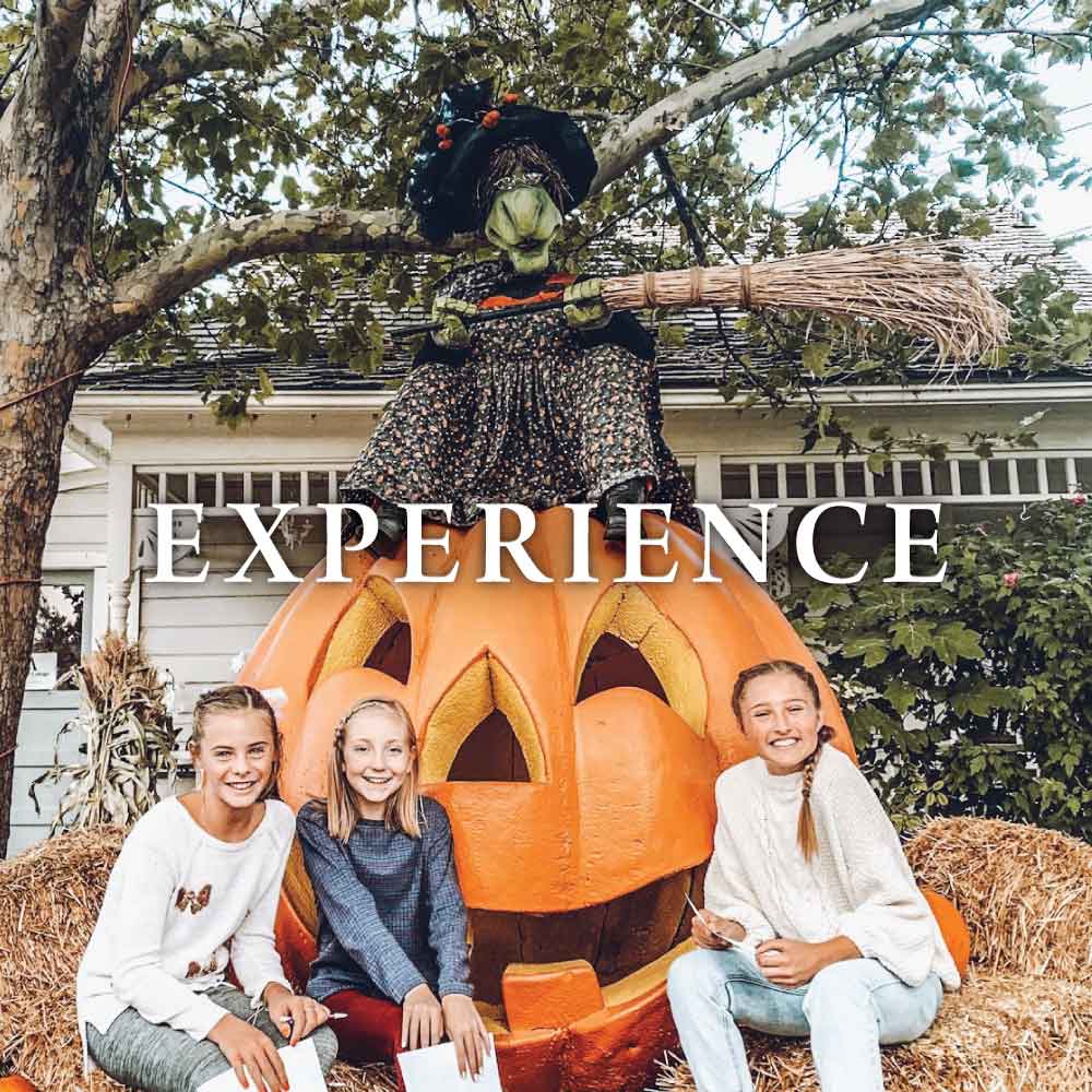 girls sitting by witch displays